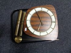 A mid century walnut clock with pendulum and weights