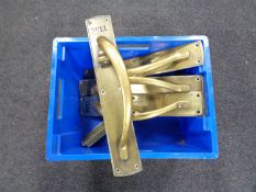 A box of two pairs of heavy brass door handles with finger plates etc