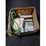 A box of hardbacked books, novels, length of rope, chess board,