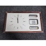 A 1970's battery operated wall clock with scroll calendar