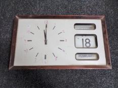 A 1970's battery operated wall clock with scroll calendar