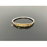 An antique 9ct gold hinged bangle CONDITION REPORT: 6.