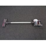 A Dyson V6 cord free electric vacuum together with a box of wall mounting bracket,