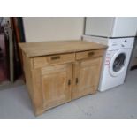 A twentieth century pine double door cabinet fitted with two drawers