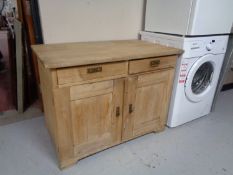 A twentieth century pine double door cabinet fitted with two drawers