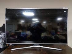 A Samsung UE50 JU6800K 50 inch lcd tv with remote