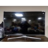A Samsung UE50 JU6800K 50 inch lcd tv with remote