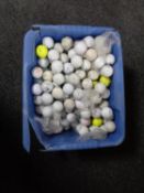 A plastic tub of golf balls