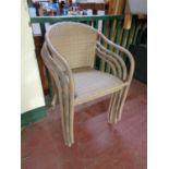 Four stacking rattan armchairs