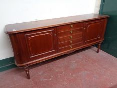 A twentieth century mahogany double door sideboard fitted with five drawers