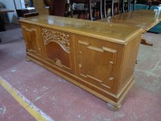 A twentieth century continental oak triple door sideboard on bun feet