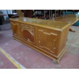 A twentieth century continental oak triple door sideboard on bun feet