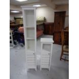 Two sets of bathroom shelves fitted with cupboards beneath