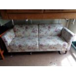 A twentieth century two seater settee in floral fabric