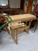 A twentieth century wooden work bench fitted with vices