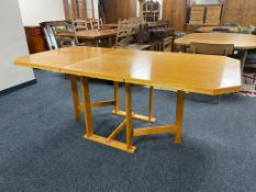 A mid century beech flap sided table