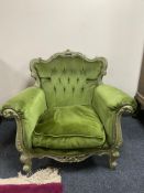 A wooden framed Rococo style armchair upholstered in green dralon fabric