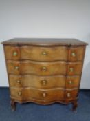 A late nineteenth century oak serpentine fronted four drawer chest on cabriole legs