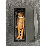 A vintage jointed teddy bear in box