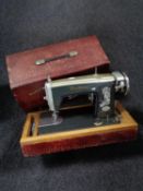 A cased Brother electric sewing machine together with a wicker sewing box