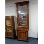 An antique mahogany hall cabinet on scroll feet with hall mirror