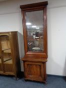 An antique mahogany hall cabinet on scroll feet with hall mirror