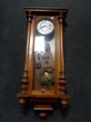 An early twentieth century mahogany cased continental wall clock with pendulum and key