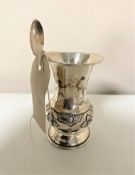 A silver embossed presentation vase together with a continental silver tea spoon