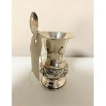 A silver embossed presentation vase together with a continental silver tea spoon