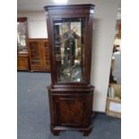 A mahogany corner display cabinet