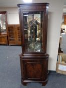 A mahogany corner display cabinet