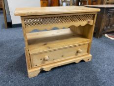 A pine entertainment stand fitted with a drawer