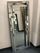 A contemporary rectangular all glass abstract mirror