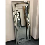 A contemporary rectangular all glass abstract mirror