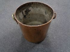 An antique copper brass handled log bin