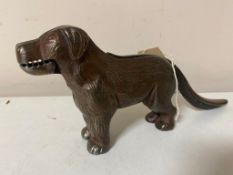 A vintage metal nut cracker in the form of a dog