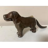 A vintage metal nut cracker in the form of a dog