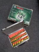 A boxed Bosch router together with an aluminium case of router bits