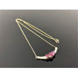 An 18ct gold diamond and ruby pendant on chain