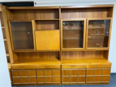 A mid century teak two piece cocktail display cabinet