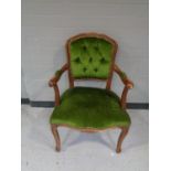 A salon armchair in green buttoned dralon