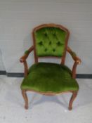 A salon armchair in green buttoned dralon