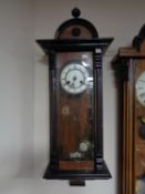 A mahogany cased eight day wall clock with brass and enamelled dial,