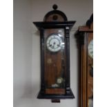 A mahogany cased eight day wall clock with brass and enamelled dial,