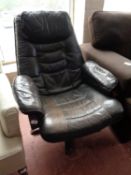 A black leather swivel adjustable armchair