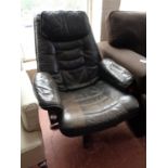 A black leather swivel adjustable armchair