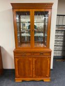 A reproduction yewwood glazed bookcase