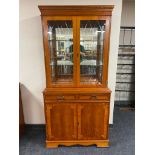 A reproduction yewwood glazed bookcase