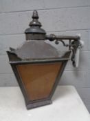 A pair of late Victorian cast iron street lights with brackets