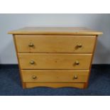 A pine three drawer chest with glass handles